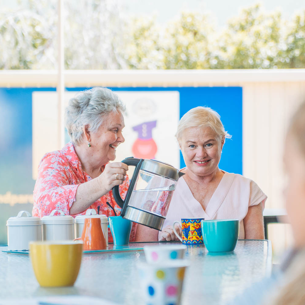 Two grandmothers and GRGWA members having a cup of tea